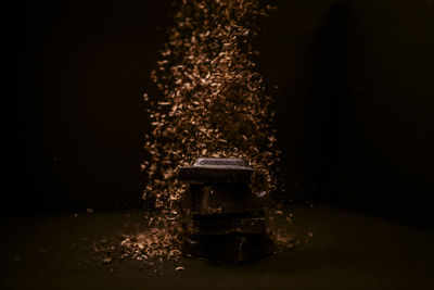 Close-up of illuminated lighting equipment against black background