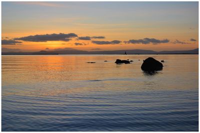 Scenic view of lake against sky during sunset