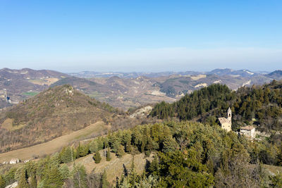 Scenic view of mountains against blue sky