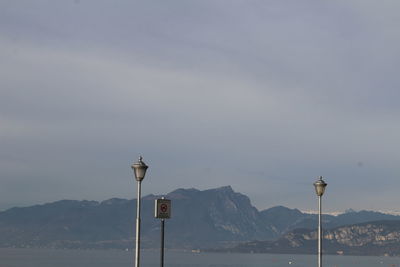 Street lights against mountains and sky