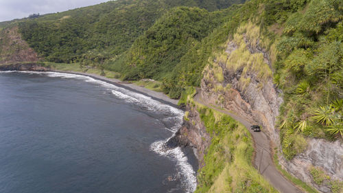 Scenic view of sea by mountains