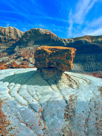 Scenic view of rock formations against blue sky