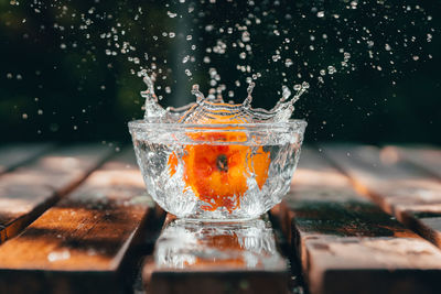 Close-up of glass of water splashing on table