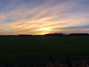 Scenic view of field against sky during sunset