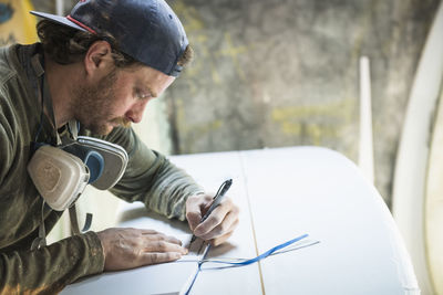 Surfboard shaper creating a new design