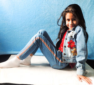 Portrait of a smiling girl sitting outdoors