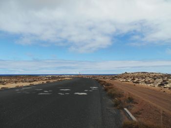 Road by sea against sky