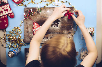 Woman making christmas decoration at home