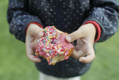 Midsection of person holding donut