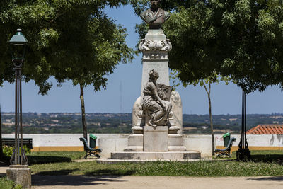 Statue in park against sky