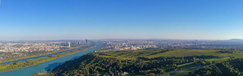 High angle view of buildings against clear blue sky