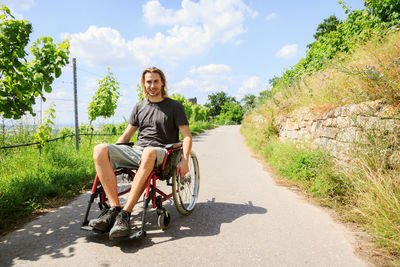 Portrait of smiling man on road against sky