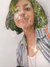 Close-up portrait of a young woman with reflection in water