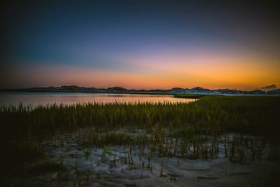 Scenic view of lake at sunset