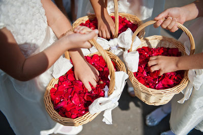 High angle view of girls holding flower baskets during wedding ceremony