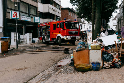 Garbage on street against buildings in city