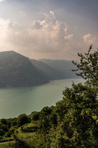 Scenic view of lake and mountains against sky