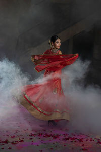 Indian girl wearing traditional dress dancing