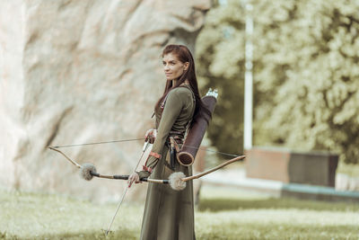 Side view of woman standing on field