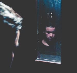 Close-up of man against window