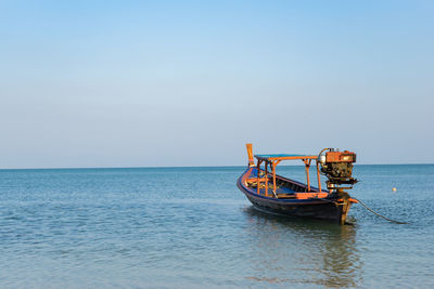 Boat in sea against clear sky