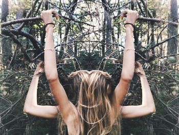 Rear view of woman in front of bare tree