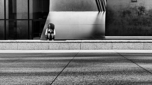 Blurred motion of train against window in city