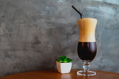 Close-up of coffee and glass on table