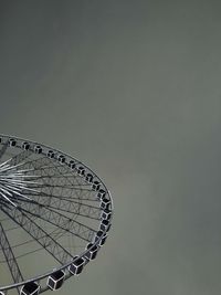 Low angle view of ferris wheel against sky