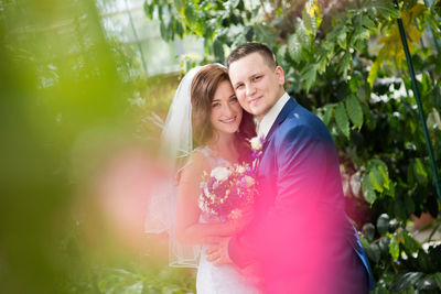 Portrait of a smiling young couple kissing outdoors