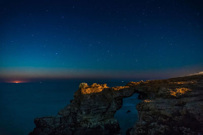 Scenic view of sea against sky at night