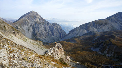 Scenic view of mountains against cloudy sky