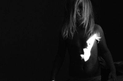 Girl standing in darkroom