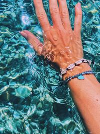 High angle view of hands in water