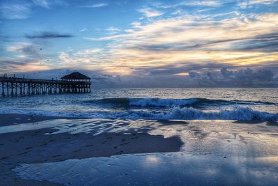 Scenic view of beach against sky during sunset