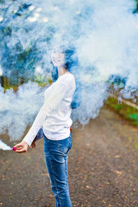 Full length of young woman standing outdoors