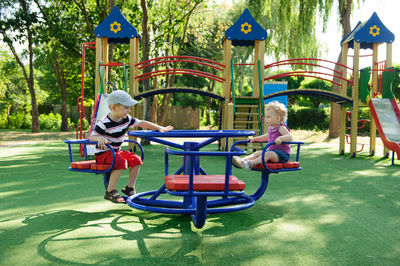 People sitting on playground at park