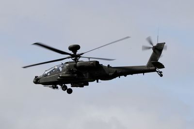 Low angle view of helicopter flying against sky