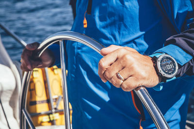 Midsection of man holding sailboat