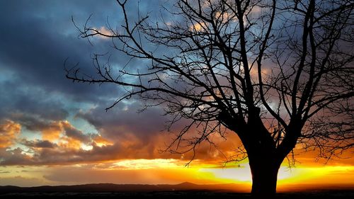 Scenic view of sea against dramatic sky during sunset