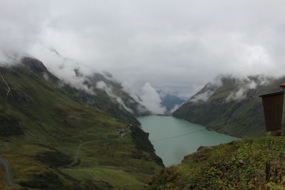 Scenic view of mountain range against cloudy sky