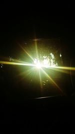 Sunlight streaming through illuminated street light at night