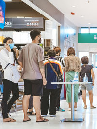 Group of people standing in shopping mall