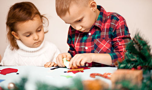 Boy drawing on paper at home