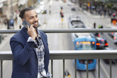 Smiling man talking via cell phone