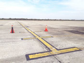 Airplane on runway against sky