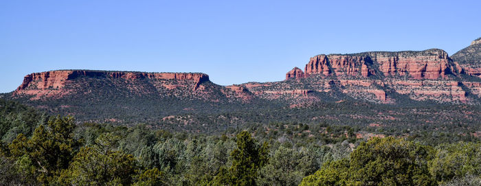 Rock formations on mountain against clear sky