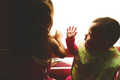 Cute girl playing with arms raised