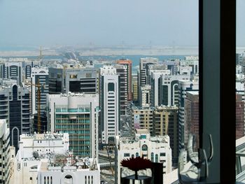 High angle view of modern buildings in city against sky