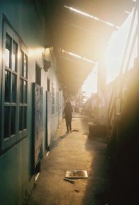 Man walking in illuminated corridor